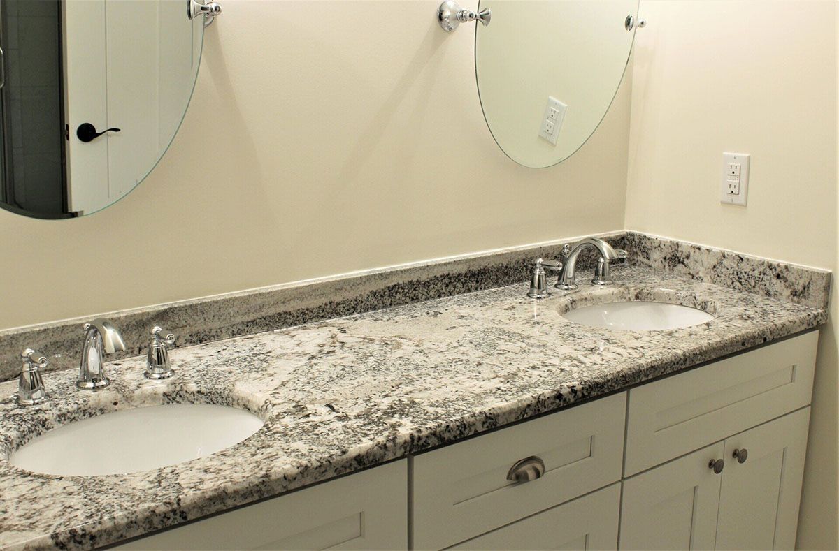 A bathroom with two sinks and two mirrors