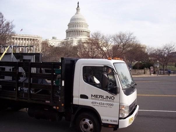 A merlino truck is parked in front of the capitol building