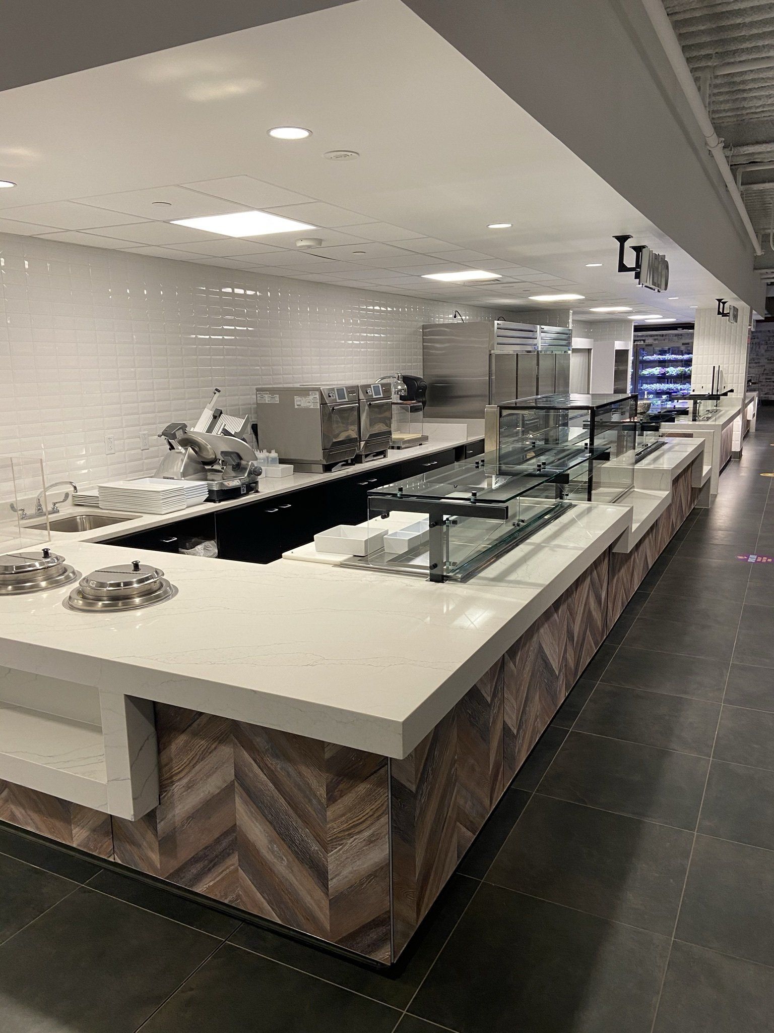 A long counter in a restaurant with a lot of food on it.