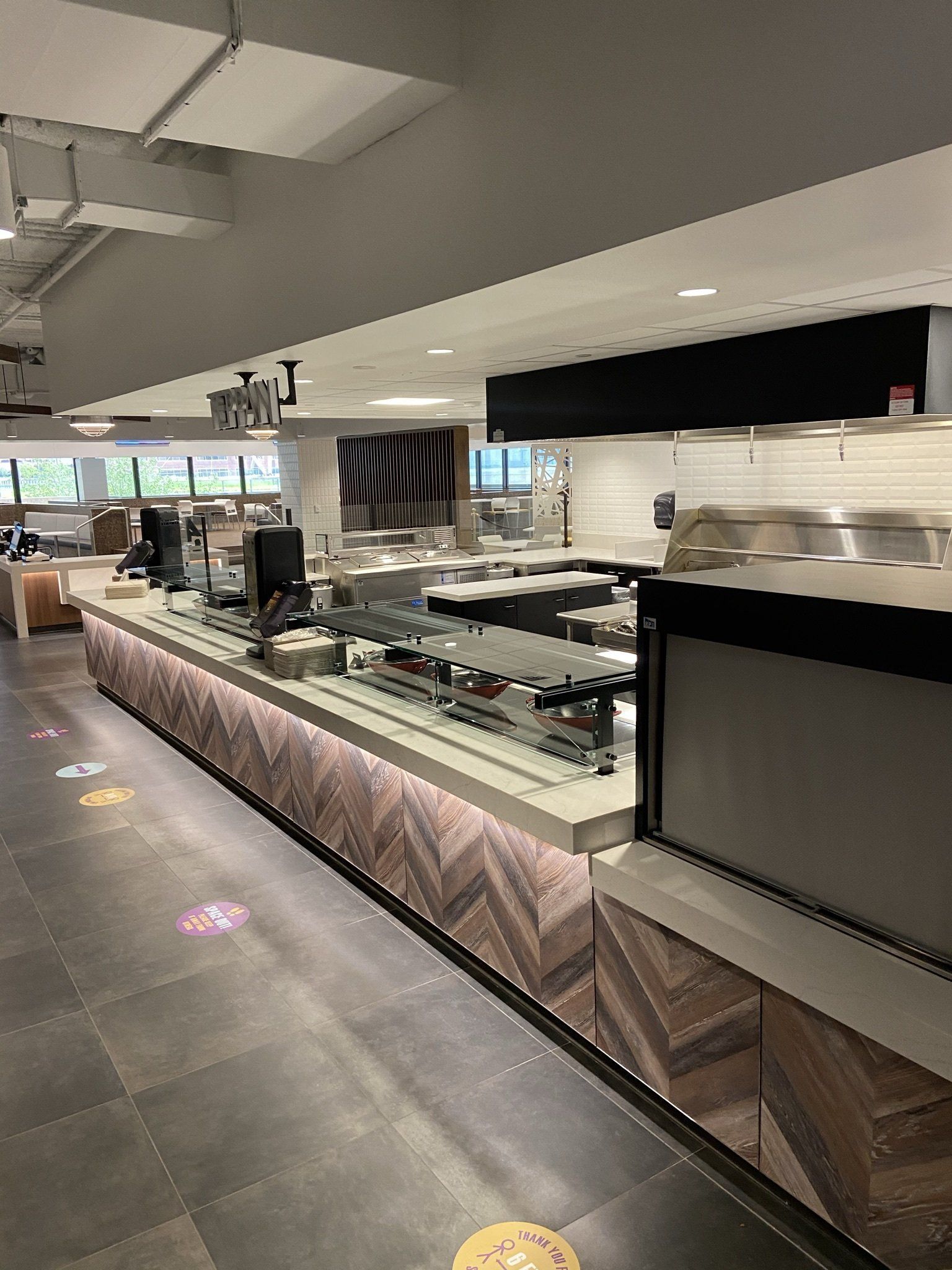 A long counter in a restaurant with a lot of food on it.