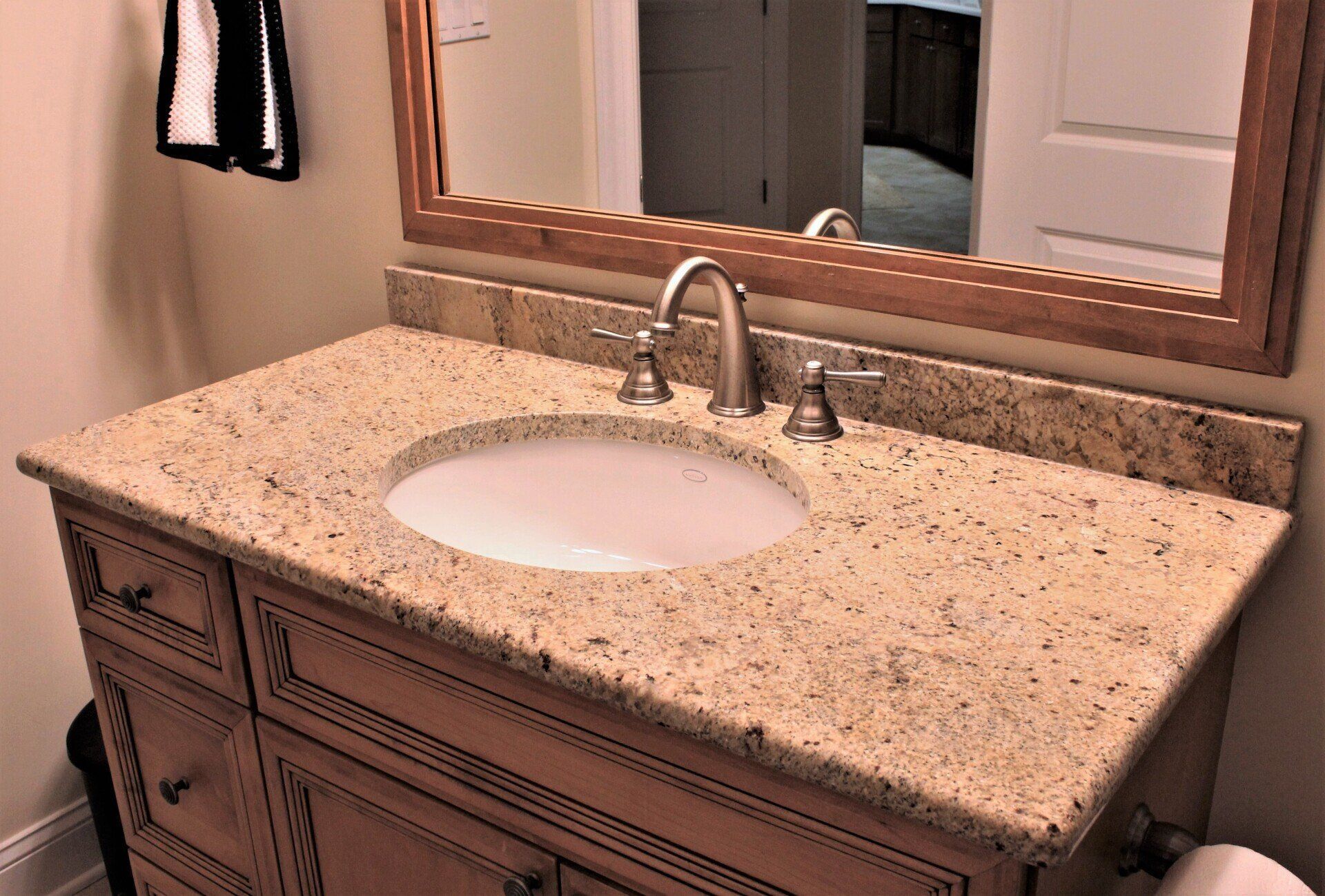 A bathroom vanity with a sink and a mirror.