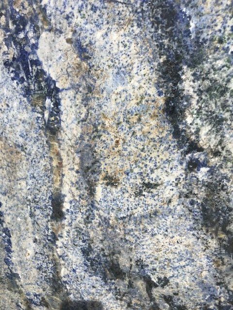 A close up of a blue granite counter top.