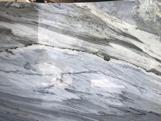A close up of a marble counter top with a gray and white marble texture.