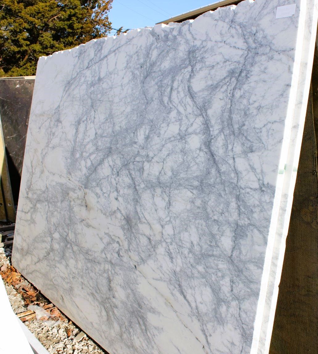 A large piece of marble is sitting on the ground