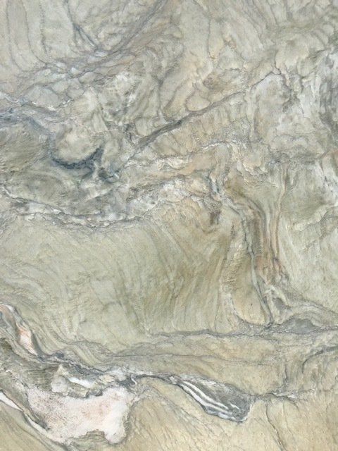 A close up of a marble counter top with a swirl pattern.