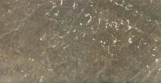 A close up of a brown surface with white spots on it.