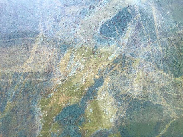 A close up of a blue and green marble texture.