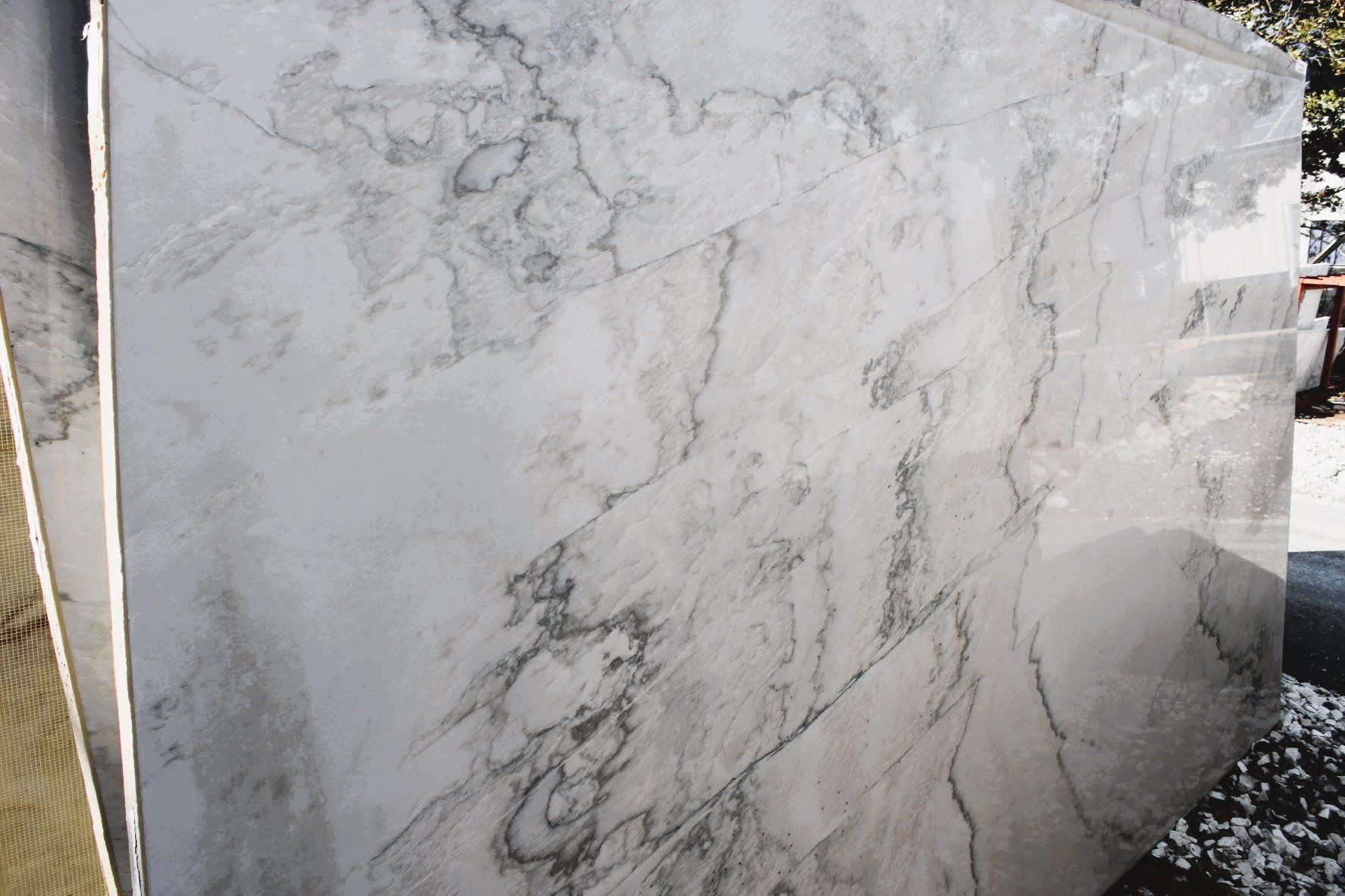 A white marble slab is sitting on top of a wooden table.