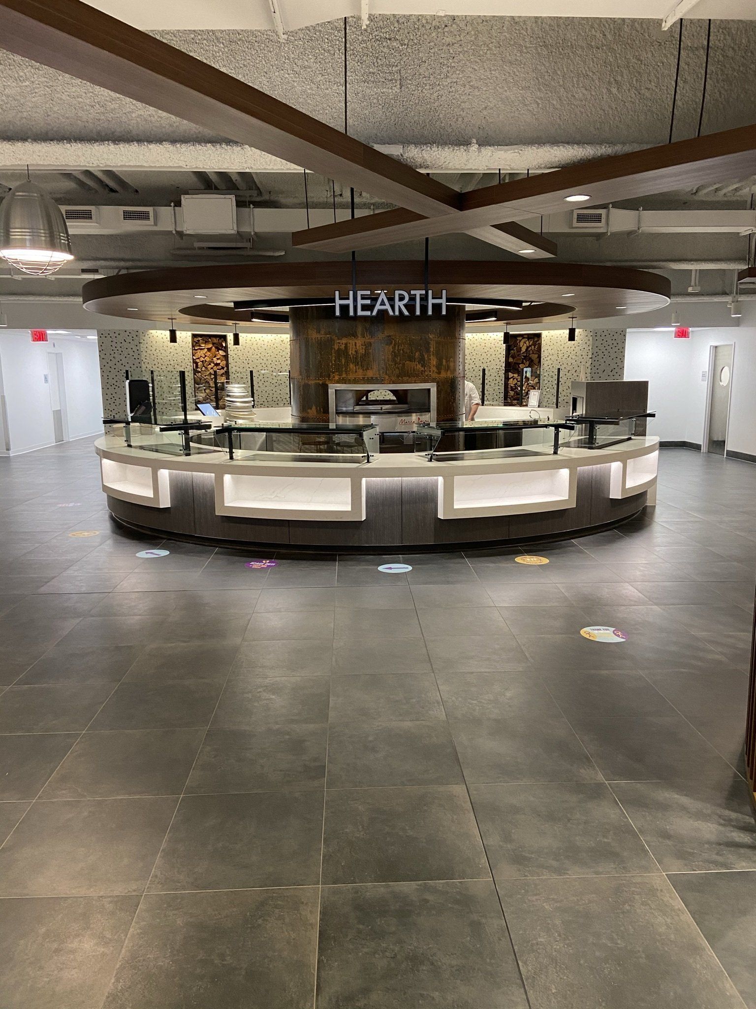 A large empty room with a counter and a sign that says hearth.