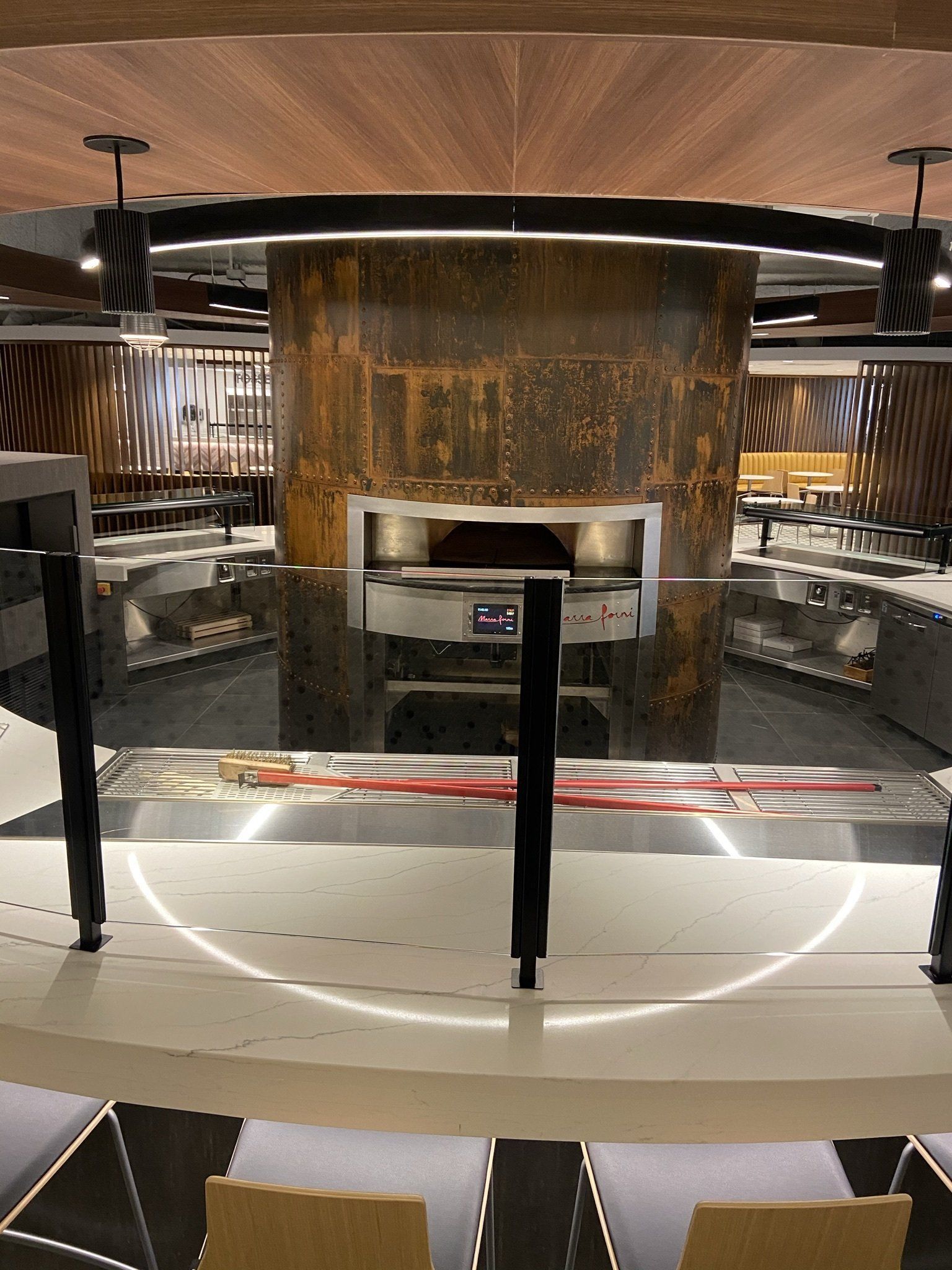 A kitchen with a pizza oven in the middle of it