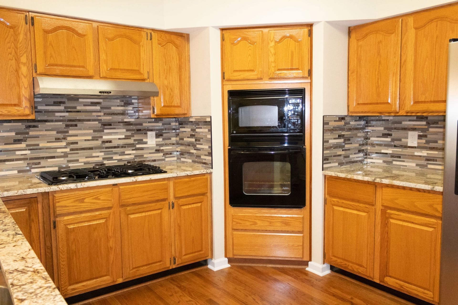 A kitchen with wooden cabinets and stainless steel appliances.