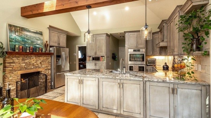 A kitchen with a large island and a fireplace.