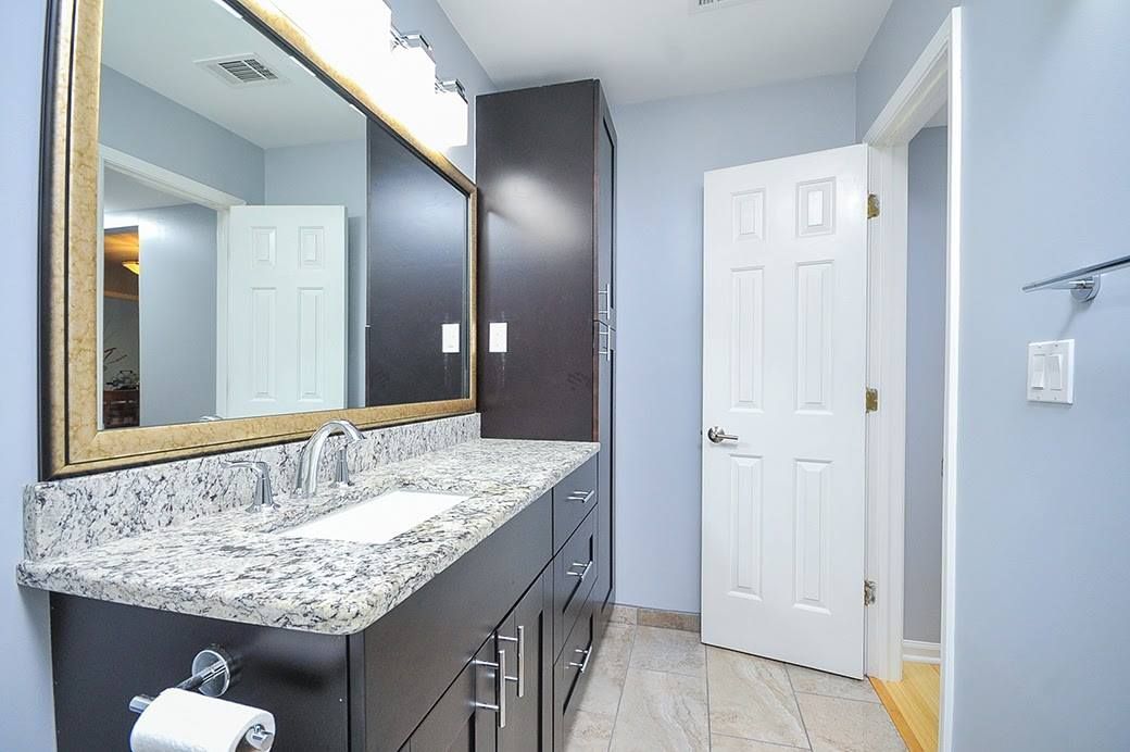A bathroom with two sinks and a large mirror.