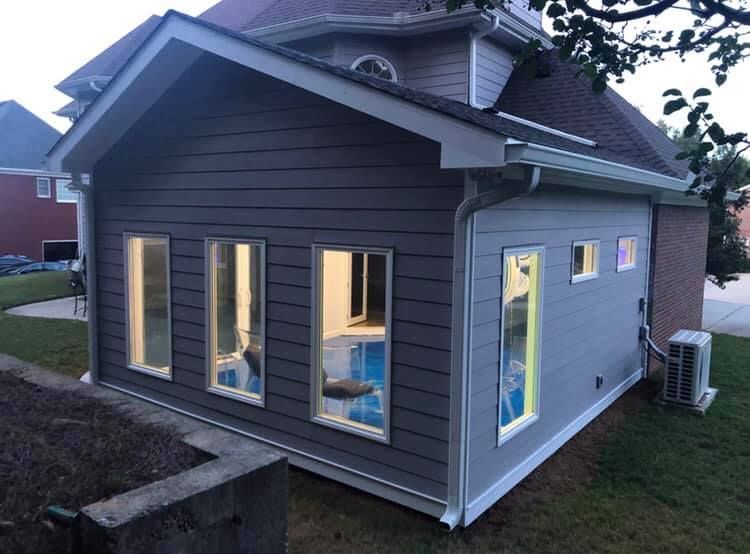 A small house with a lot of windows on the side