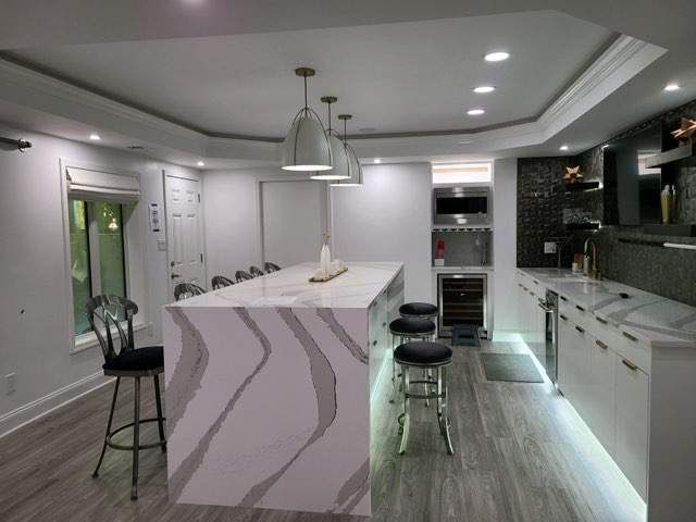 A remodeled kitchen with a large island and stools