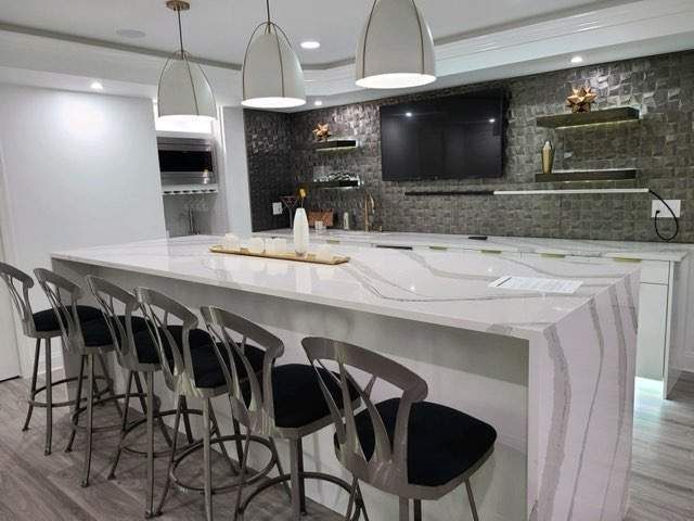 Kitchen remodeling with a long white countertop and stools