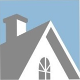 Gray and white house roof with chimney and arched window against a light blue sky.