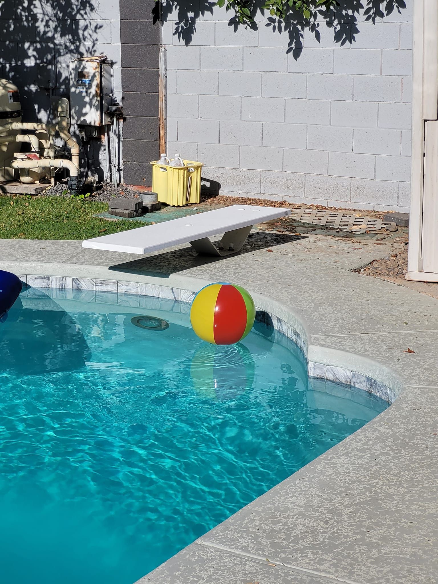 A beach ball is floating in a swimming pool