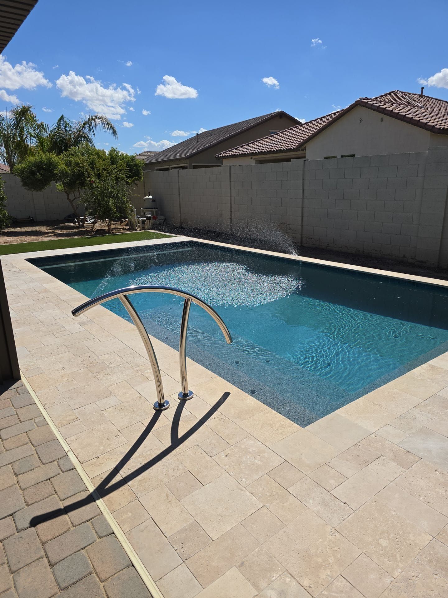 A large swimming pool with a staircase leading to it