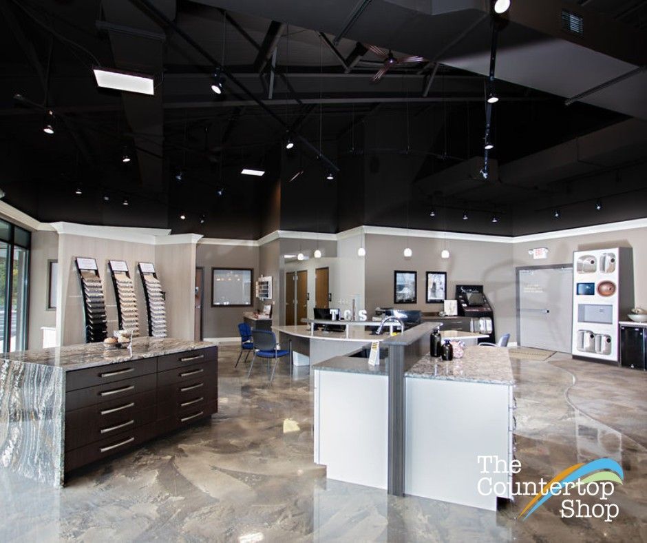 Interior of a countertop showroom with samples, displays, and a black ceiling.