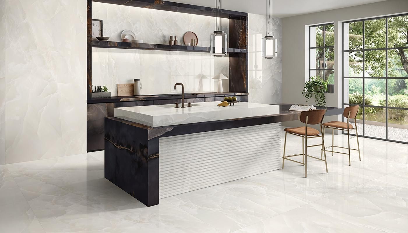 Modern kitchen with marble island, dark shelving, and a windowed dining area with chairs
