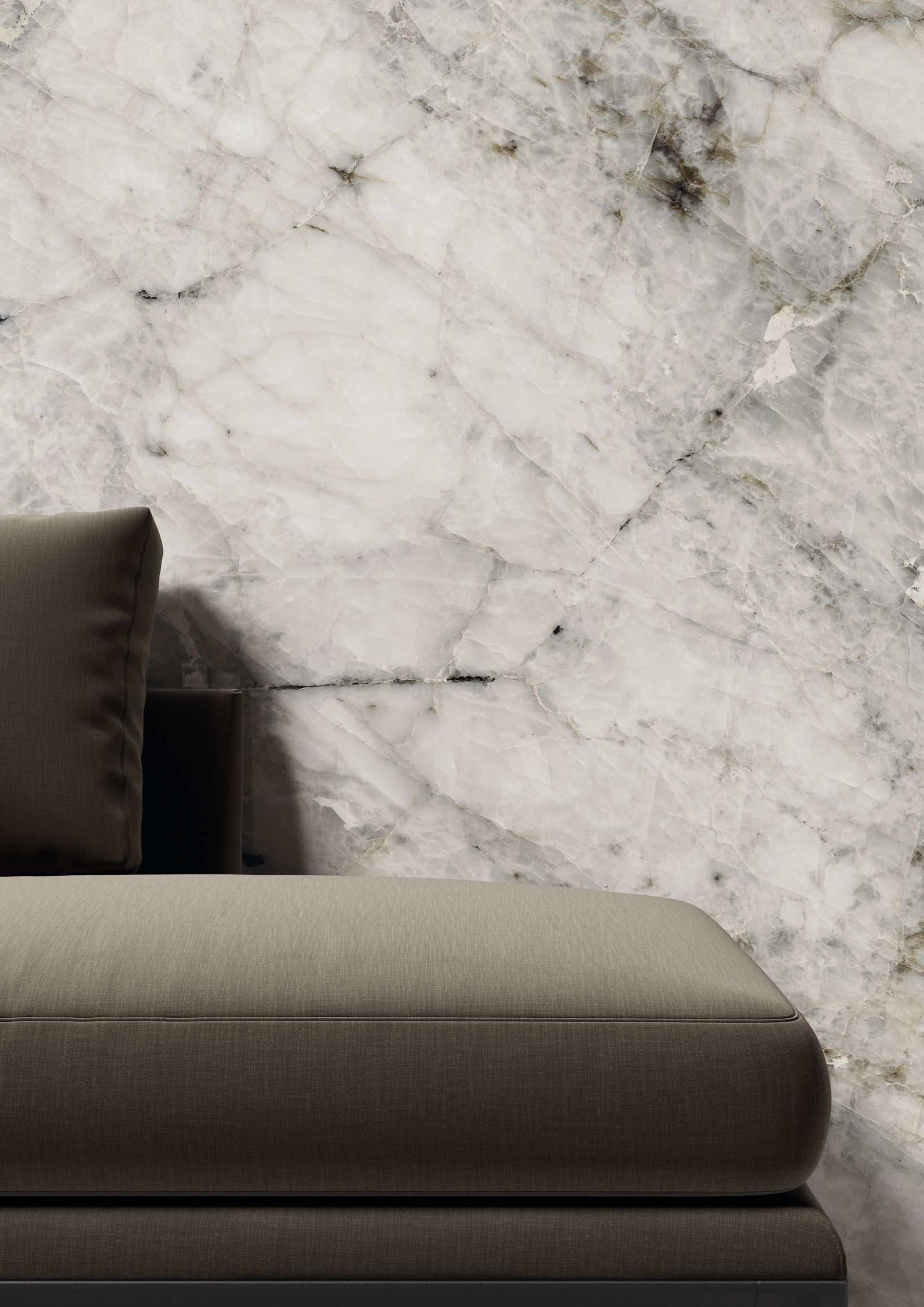 Gray sofa against a white marble wall backdrop