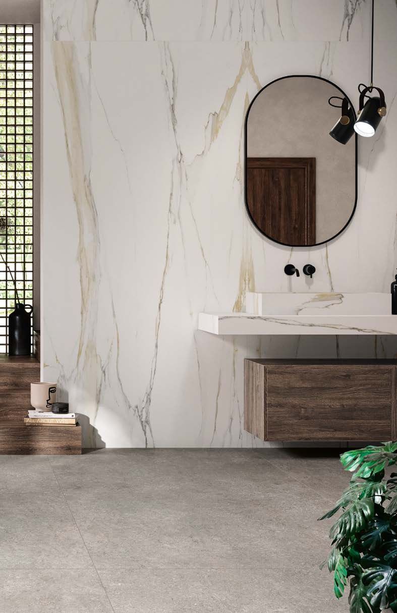 Modern bathroom with white marble wall, oval mirror, wood vanity, and concrete floor