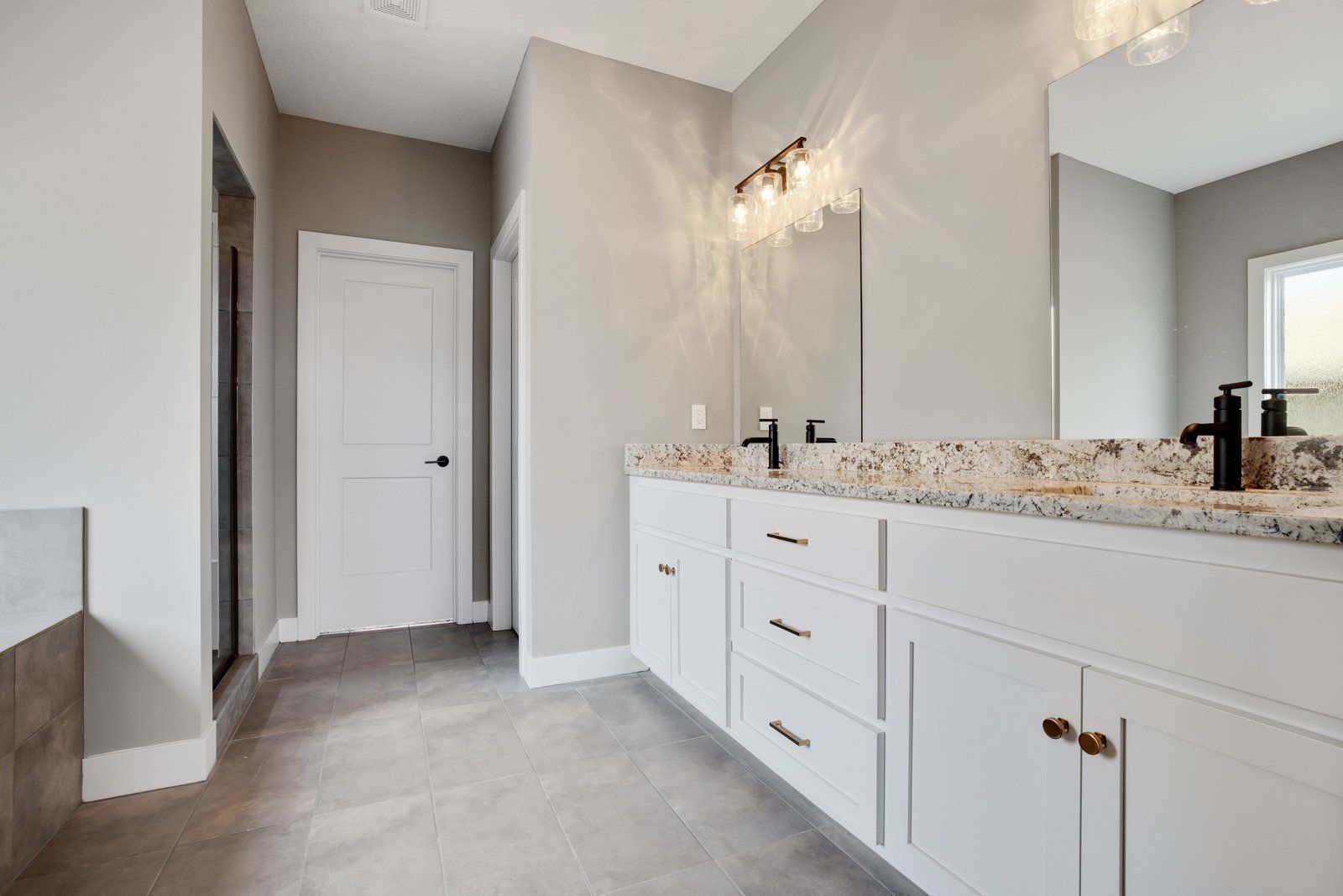 A bathroom with two sinks and a large mirror.