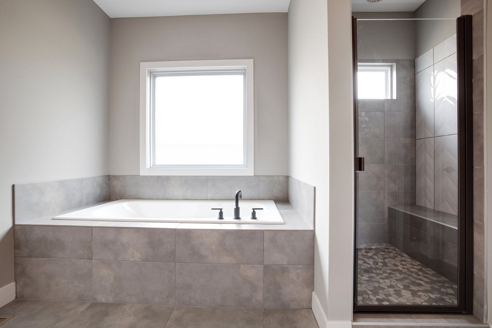 A bathroom with a tub and a walk in shower.
