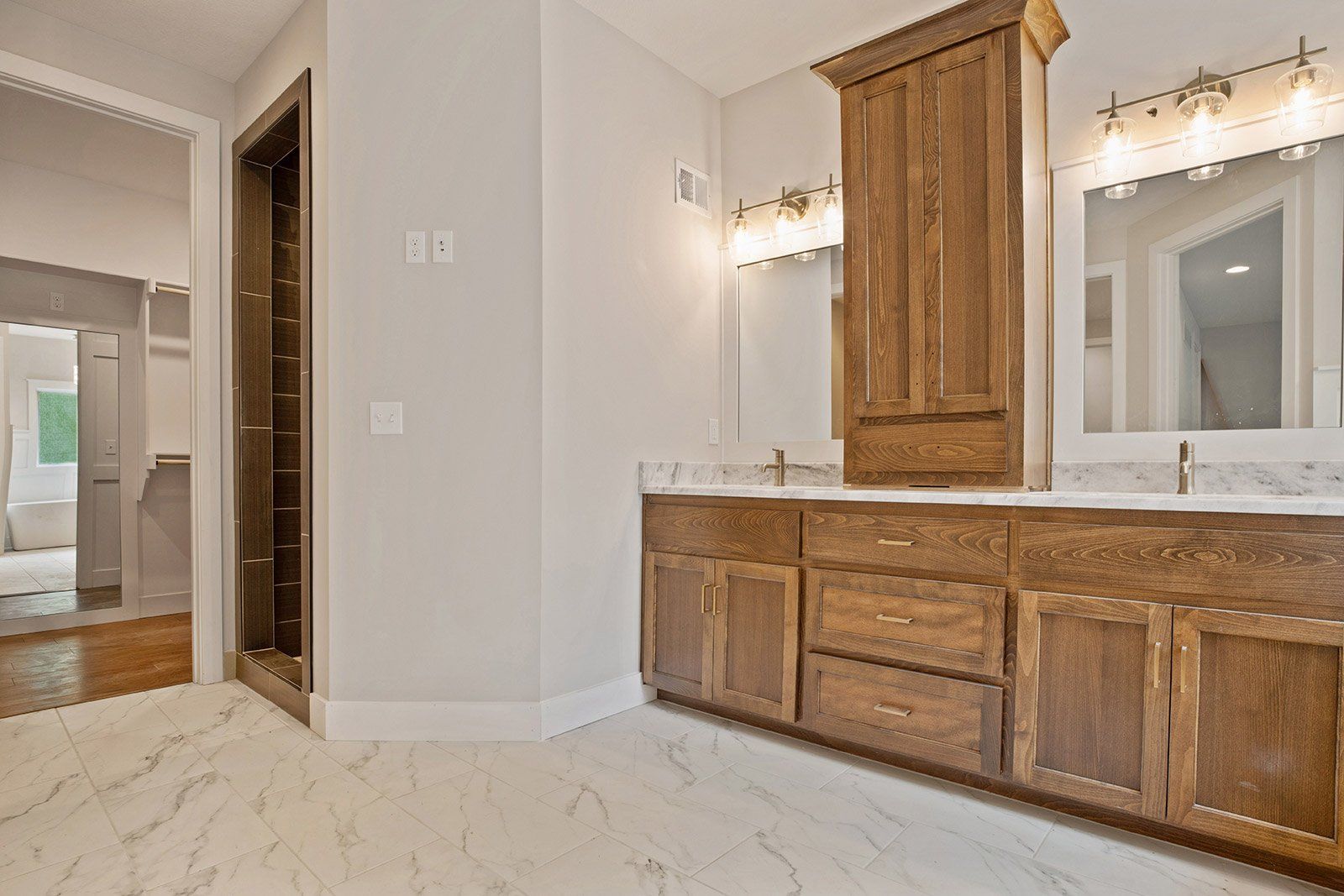 A bathroom with two sinks and two mirrors.