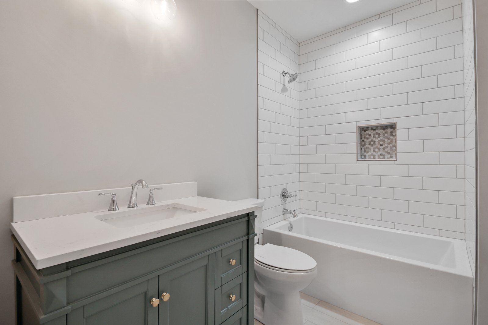 A bathroom with a sink , toilet , bathtub and shower.