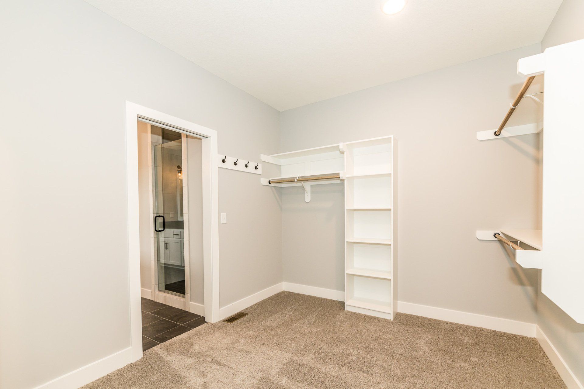 An empty bedroom with a walk in closet and a bathroom.