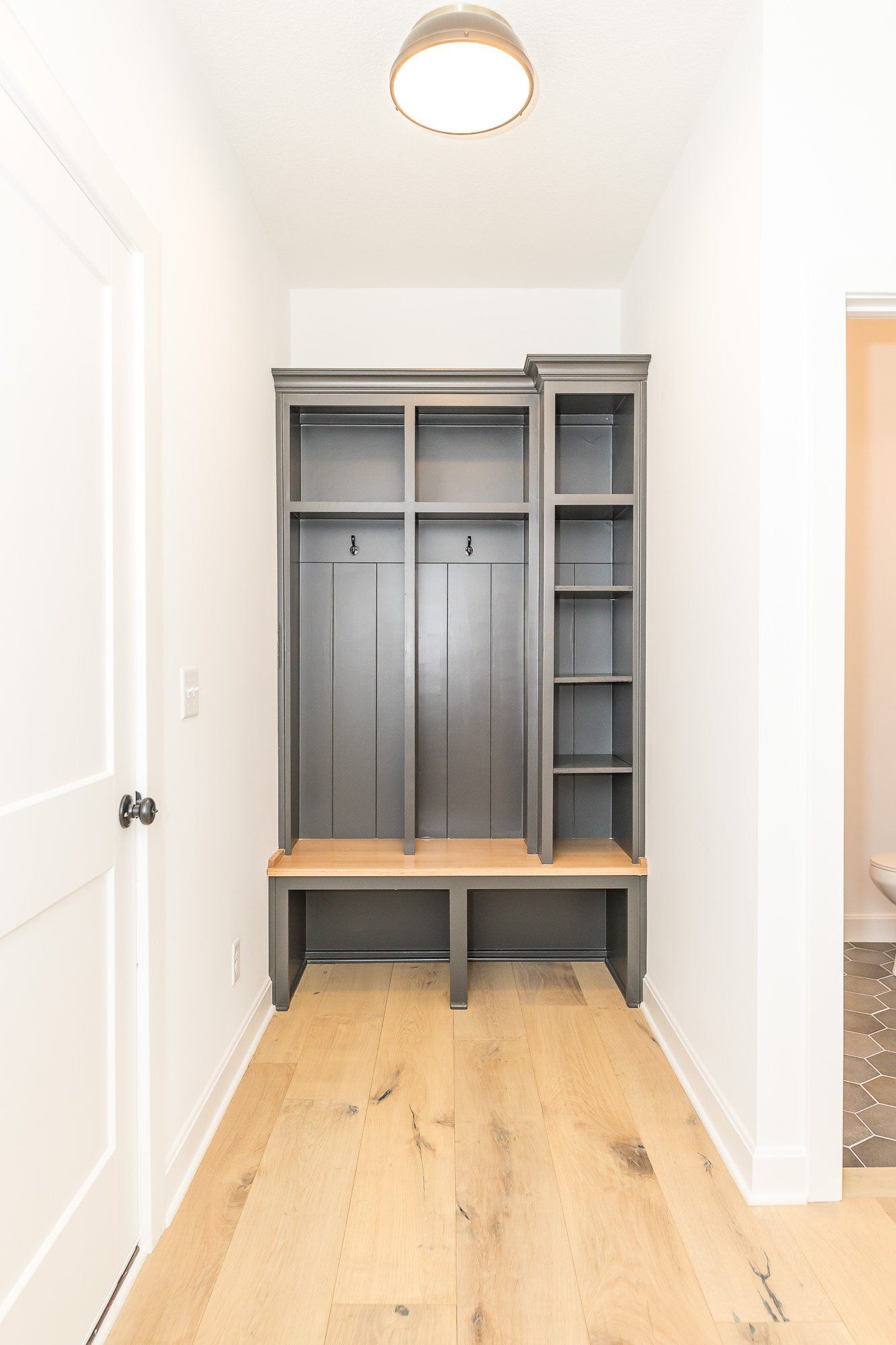 A hallway with a locker and a bench in it