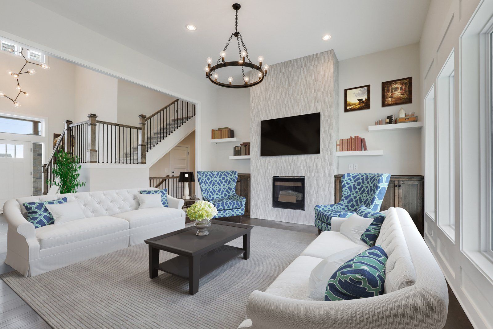 A living room with a couch , chairs , coffee table and television.