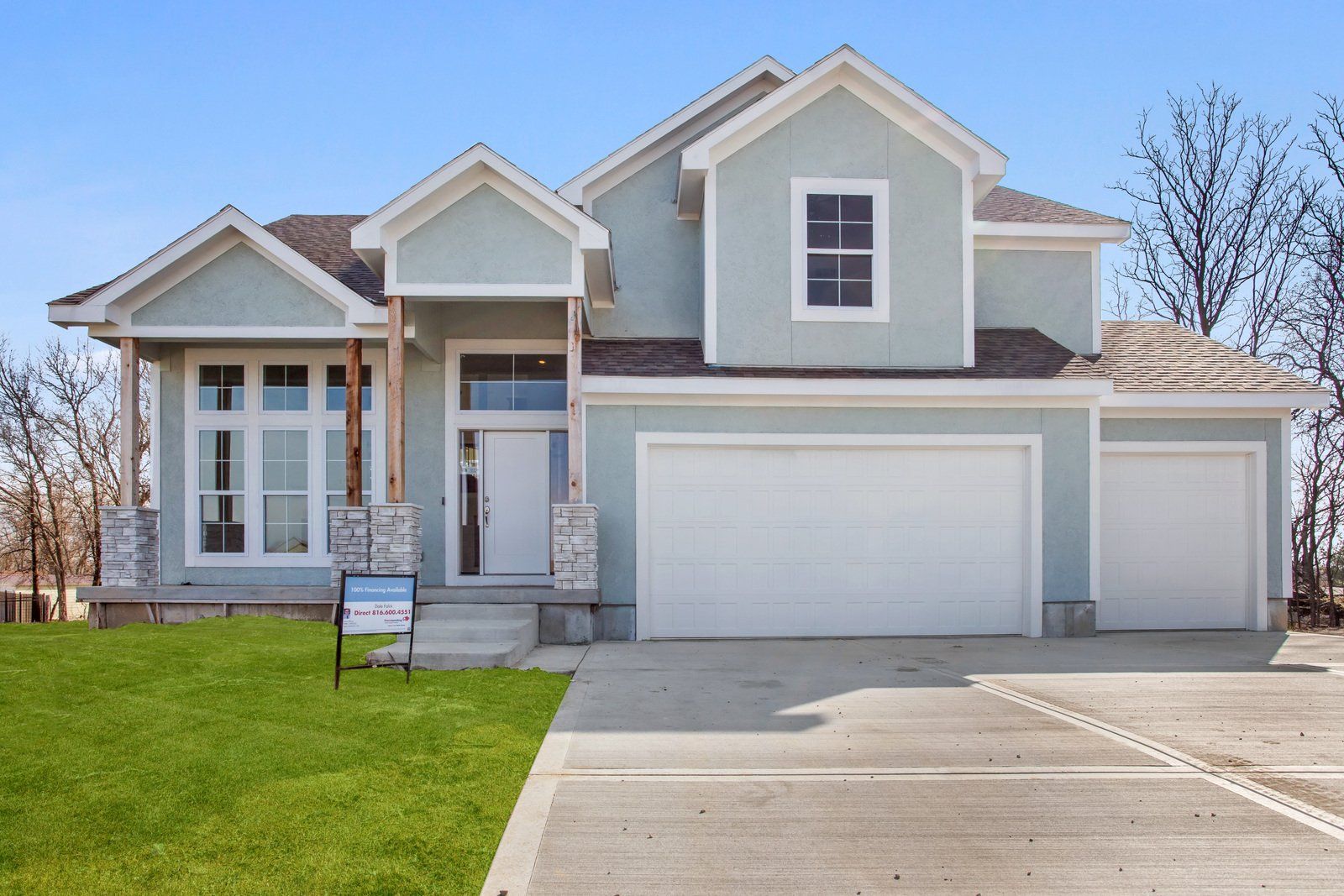 A house with a for sale sign in front of it