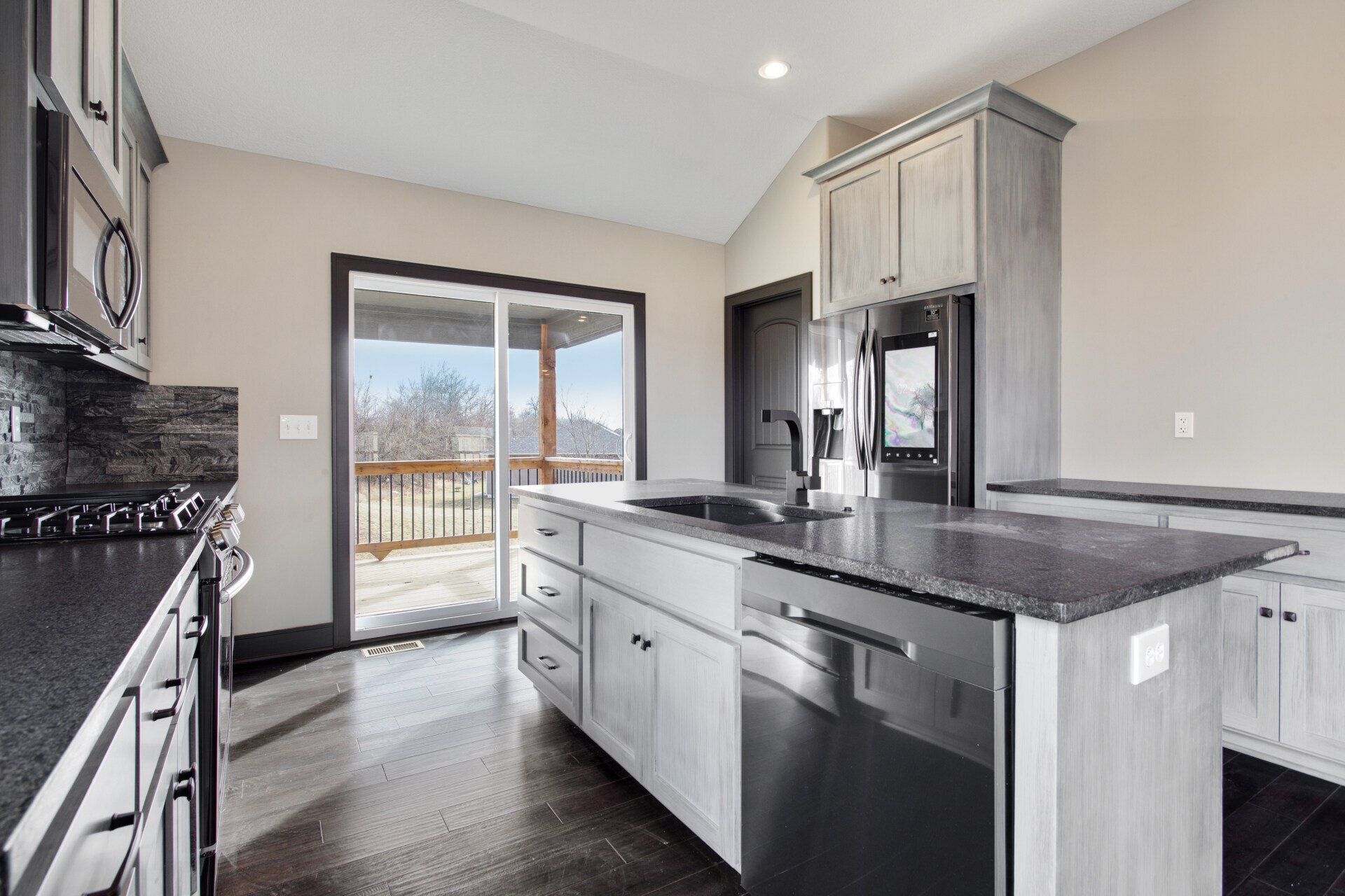 A kitchen with stainless steel appliances and granite counter tops.