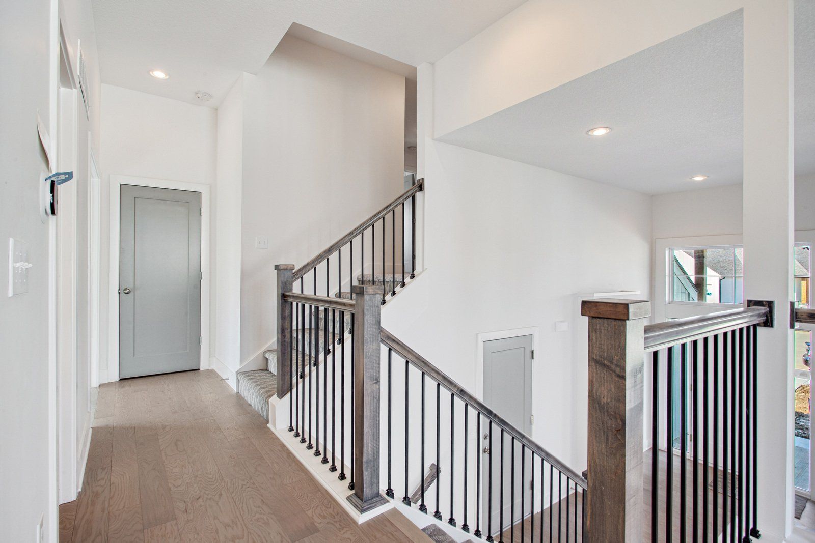 A hallway with stairs leading up to the second floor of a house.