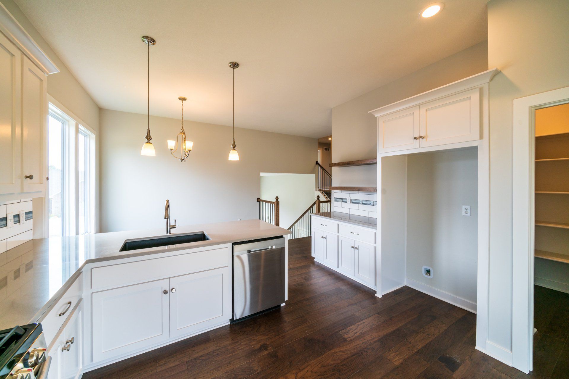 A kitchen with white cabinets and stainless steel appliances