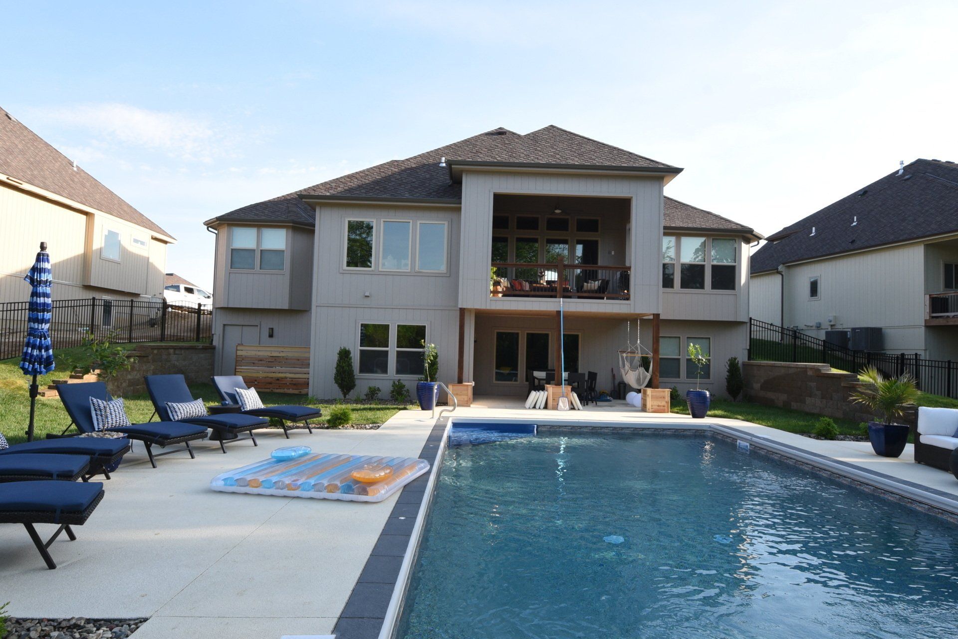A large house with a large swimming pool in front of it