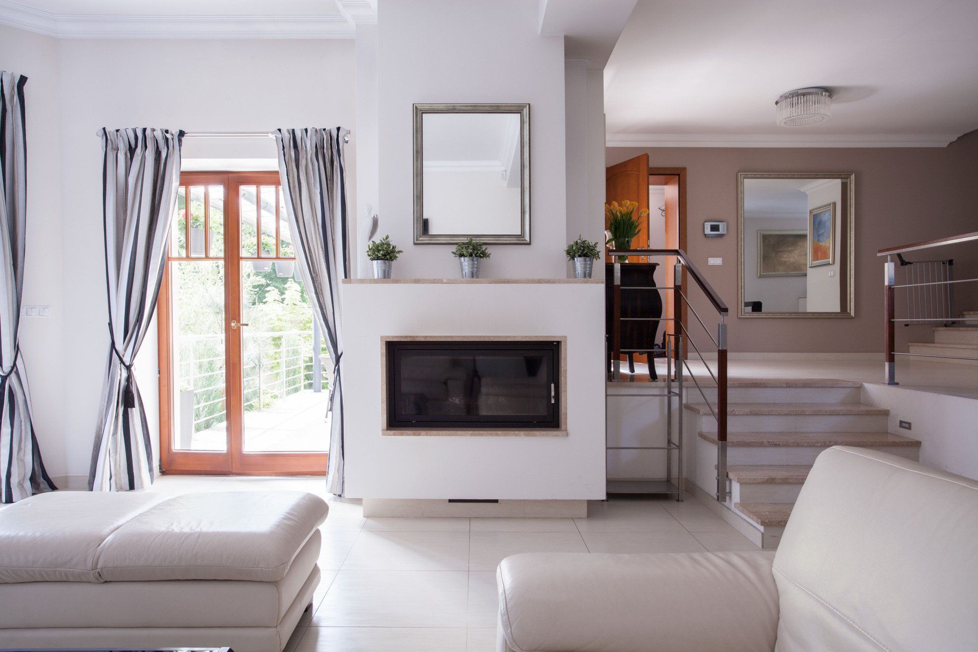 There is a fireplace in the middle of the living room.