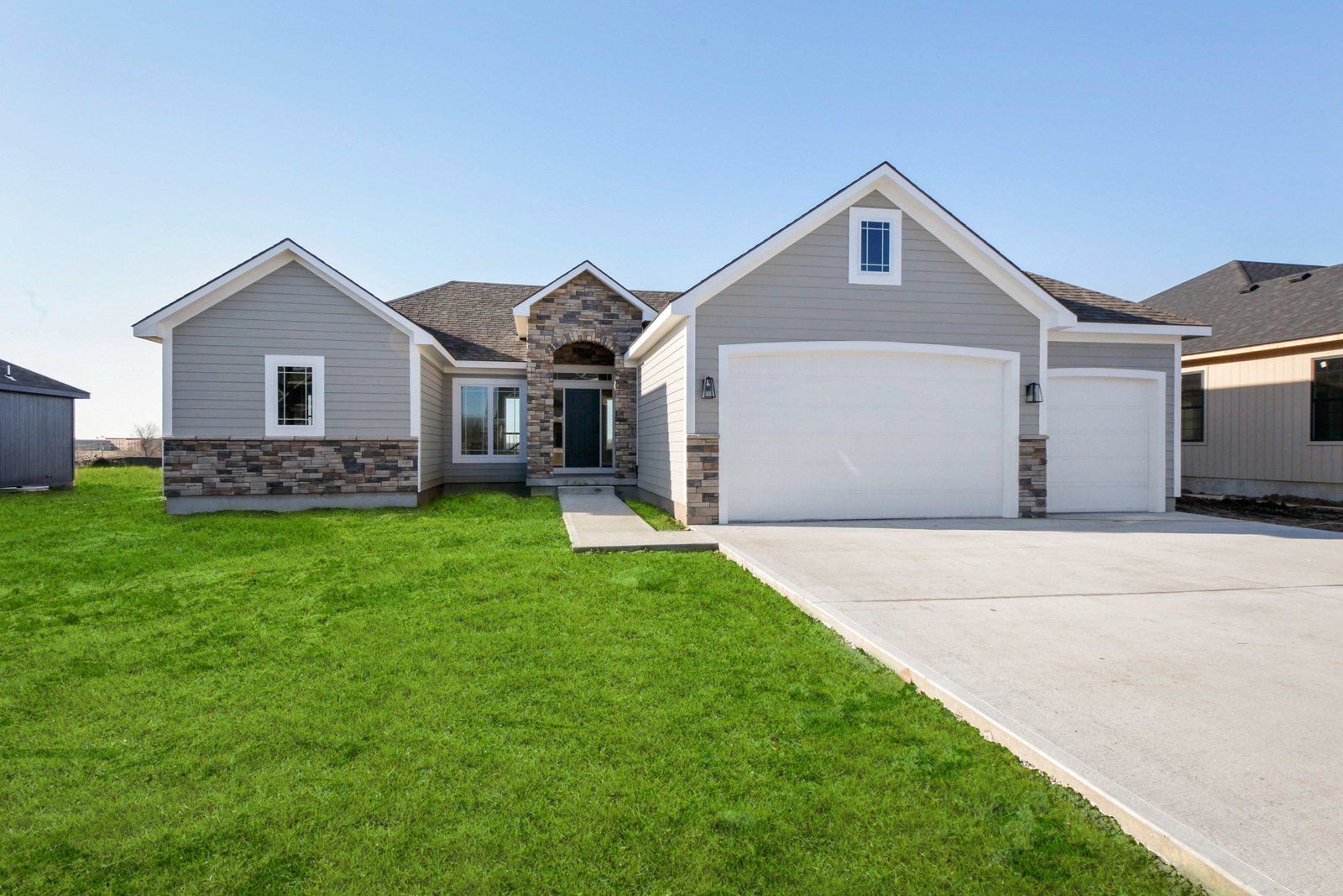 A large house with a lot of grass in front of it.