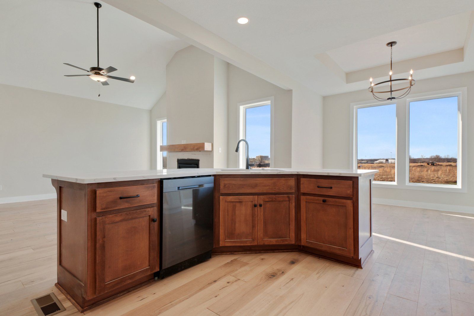 A kitchen with a large island and stainless steel appliances