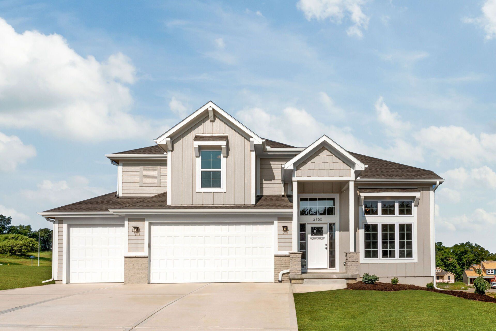 A large house with a lot of windows and a large garage.