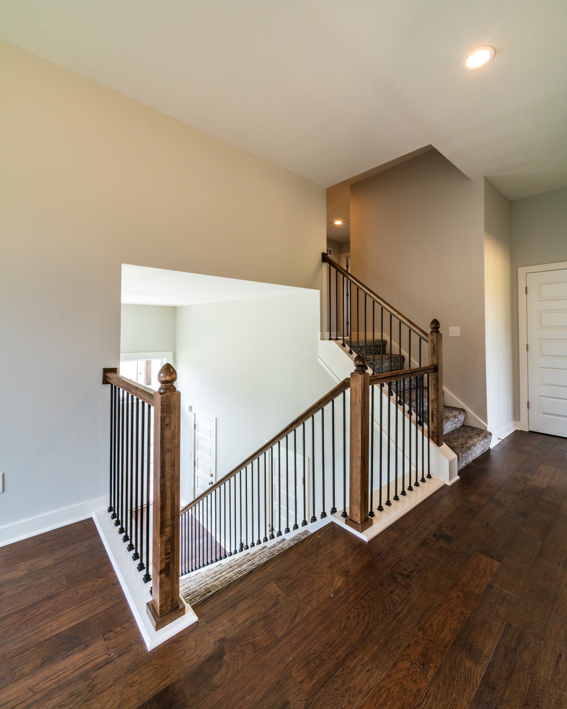 A staircase in a house with a wooden railing