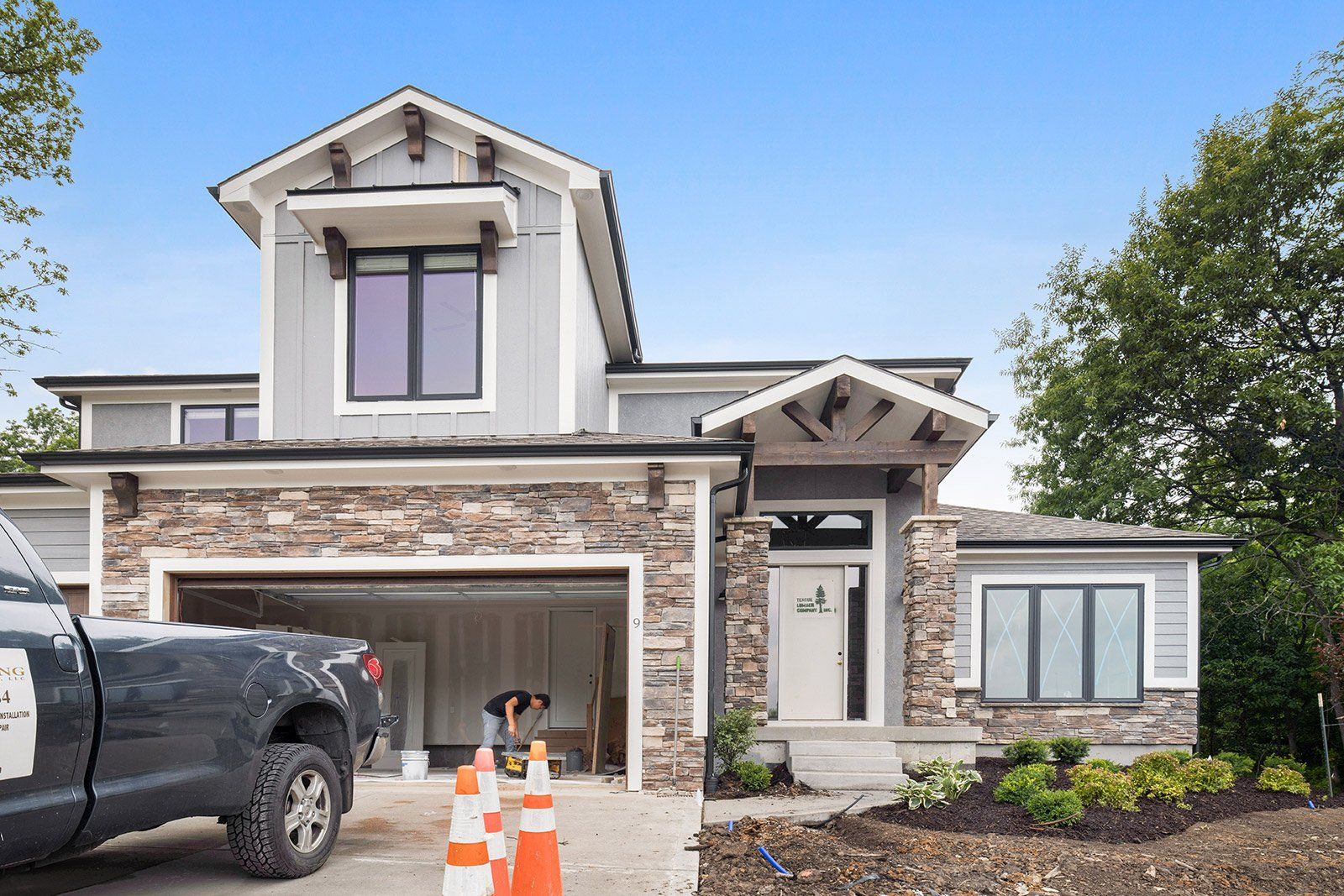 A truck is parked in front of a house under construction.