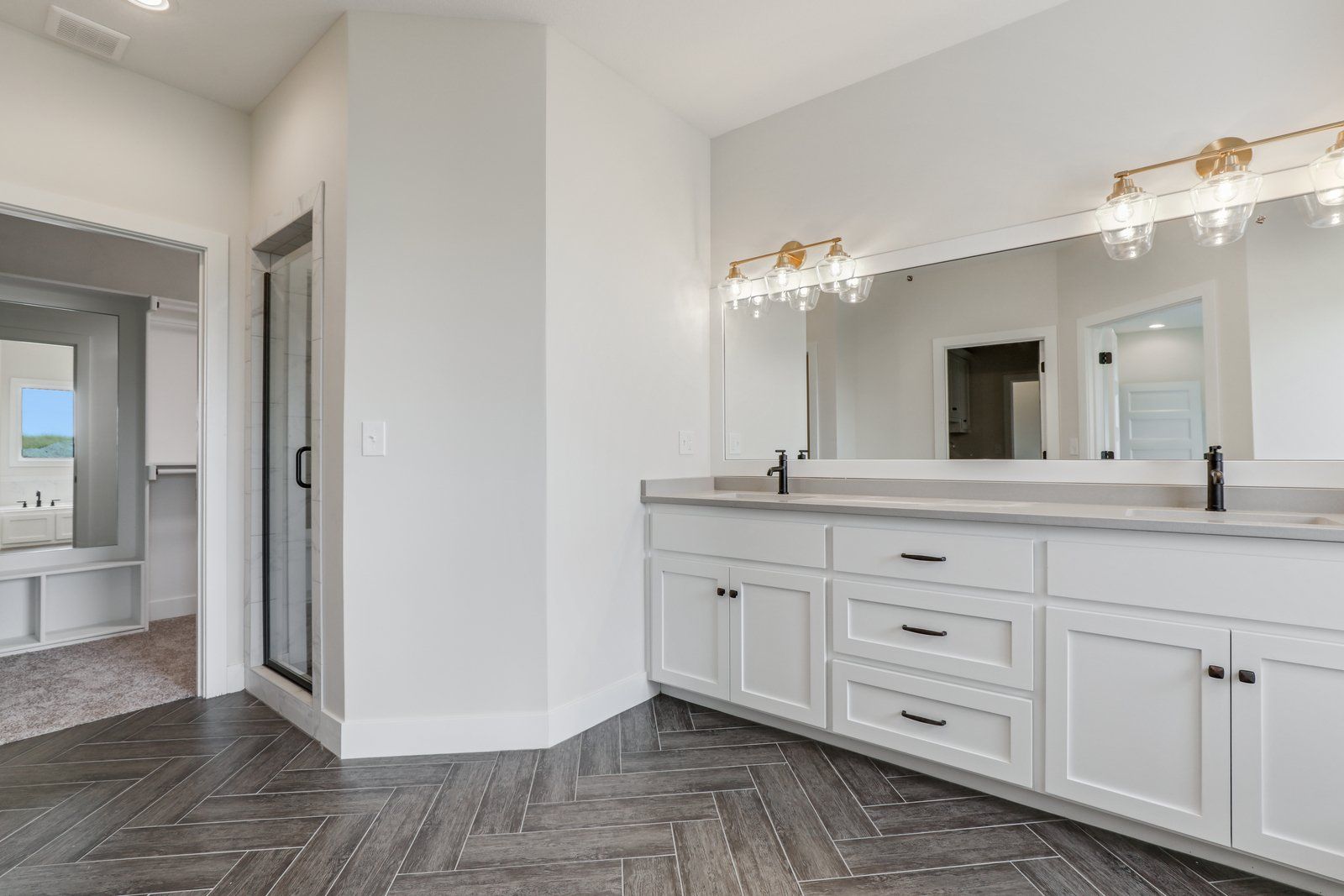 A bathroom with two sinks and a large mirror.