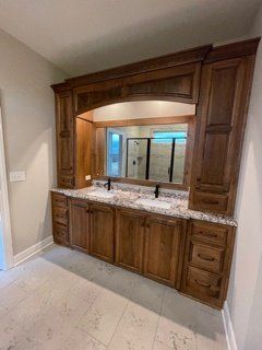A bathroom with two sinks and a large mirror.