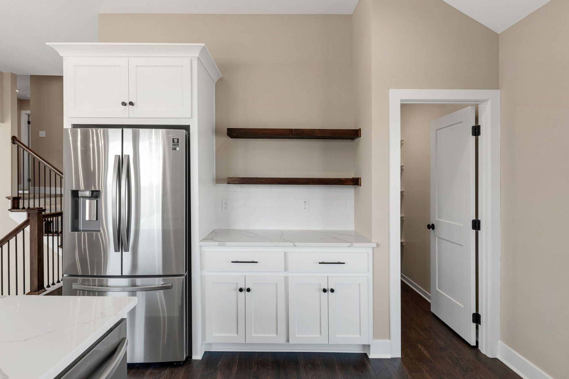 A kitchen with stainless steel appliances and white cabinets