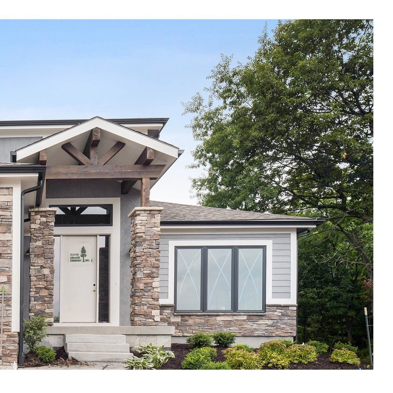 A house with a stone facade and a white door