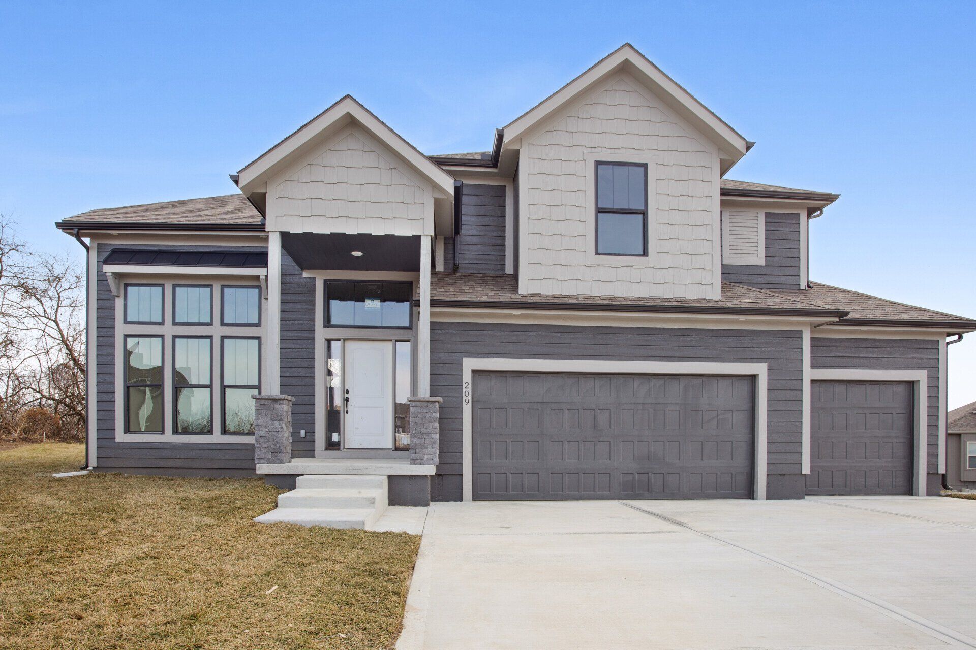A large house with two garages and a large driveway